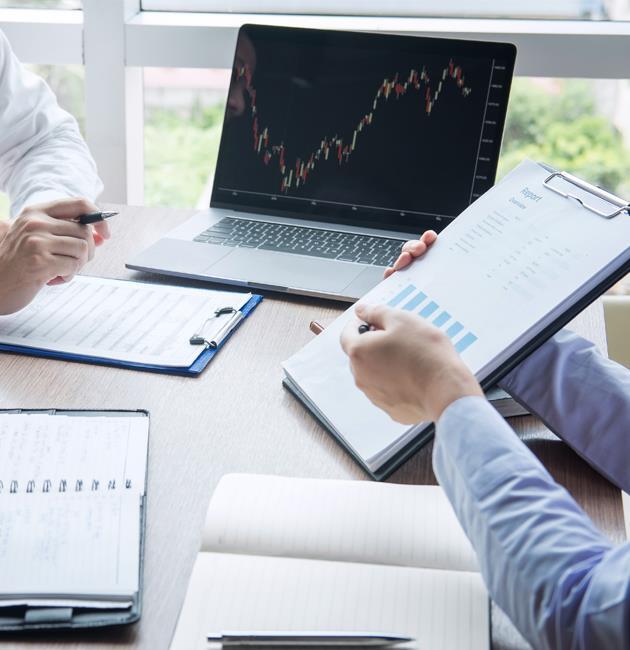 Professionals discussing stock market performance and financial reports